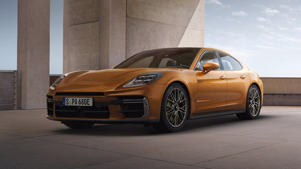 A side photo of a dark beige porsche panamera turbo s being inside a parking building